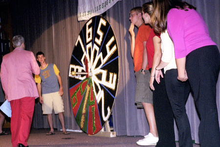 Freshman Kevin Morse spins the wheel at the SAC sponsored <i>Right is the Price</i> hosted by Mark (VanderHaar) Marker.
 - Photo by Mykle Harchfield Johnson