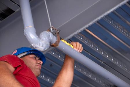 A worker checks the balance of a pipe in White Hall. - Photo by Morris Abernathy