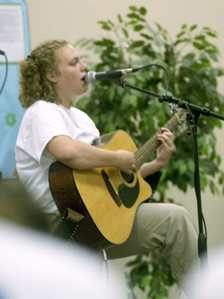 Freshman Amanda Larson entertains the crowd at the Open Mic concert during New Student Orientation.
 - Photo by Justin Veneman