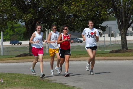 Charley Moss, Jill Konkol, Candace Cross and Lydia Bond run on campus during cross country practice. - Photo by Morris Abernathy