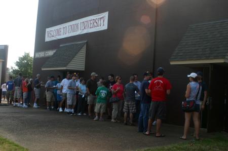 Approaching the opening hour of move-in, many families arrived to beat the heat and were lined up outside of Watters Commons as they waited to take their first steps towards moving into their dorms. - Photo by Stephanie Schroeder