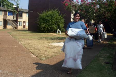 Cassie Badillo, a nursing major from Brownstown, MI, carries her stuff to her new room in Hurt Residence Complex. - Photo by Stephanie Schroeder