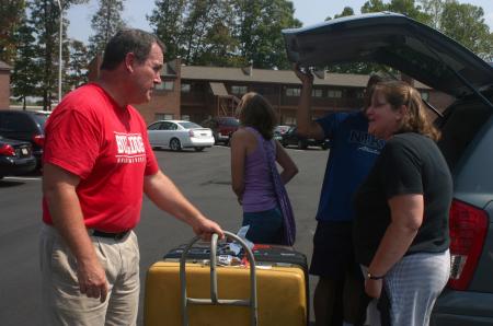 Keith Absher helps Carolyn and Bruce Smith move their daughter Bonnie, undeclared major, from Essex, Vt., into McAfee Residence Complex.  - Photo by Stephanie Schroeder
