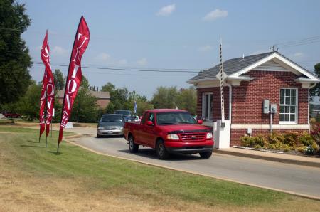 Cars stream past the welcome house onto campus as returning students and Union flags welcome them. - Photo by Stephanie Schroeder