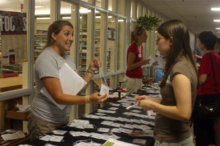 Brittany Howerton, senior public relations major and Focus leader, gives Rebecca Montgomery, an engineering major from Memphis, Tenn., and other new students their name tags they use for orientation before classes begin. - Photo by Stephanie Schroeder