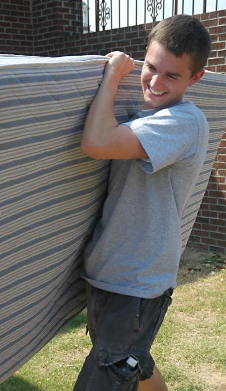 Junior Focus Group Leader Mark Trammell helps new students move into their dorm rooms. - Photo by Matthew Diggs