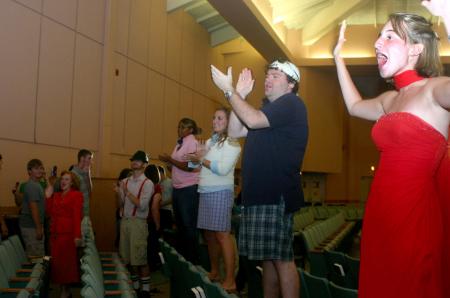 Kasey Kobb, Josh Clarke, Brittany Howerton, Wende Jackson and other SAC members cheer on and welcome the freshman as they enter the chapel for SAC's Game Show during Focus orientation. - Photo by Stephanie Schroeder