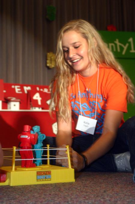 Katie Veach plays Rock 'Em, Sock 'Em Robots to determine the next contestant during the SAC game show at orientation. - Photo by Stephanie Schroeder