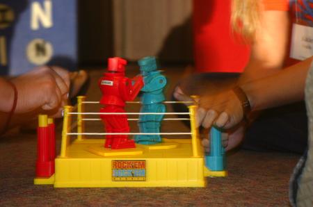 Cassie Badillo and Katie Veach play Rock 'Em, Sock 'Em Robots to determine the next contestant during the SAC game show. - Photo by Stephanie Schroeder