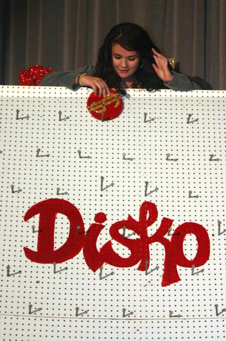 Esperanza Aguilar drops a disk as she tries to win a prize playing Disko during the SAC game show.  - Photo by Stephanie Schroeder