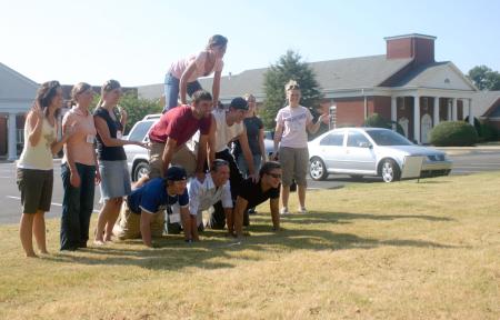Kirby Maxwell's Focus group creates a pyramid in front of Englewood Baptist Church as part of their scavenger hunt through Jackson. - Photo by Stephanie Schroeder