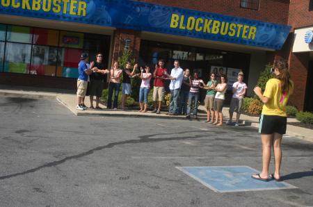 Kirby Maxwell's Focus group stands in front of Blockbuster posing with the take two motion as part of their scavenger hunt through Jackson. - Photo by Stephanie Schroeder