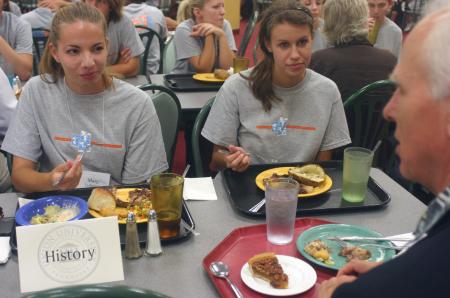Mary Alisa Techentin, of Thompson Station, Tenn., and Rachel Pettigrew, of Jackson, Tenn., talks with Stephen Carls, history department chair, during the Dinner with your Department event at New Student Orientation. - Photo by Stephanie Schroeder