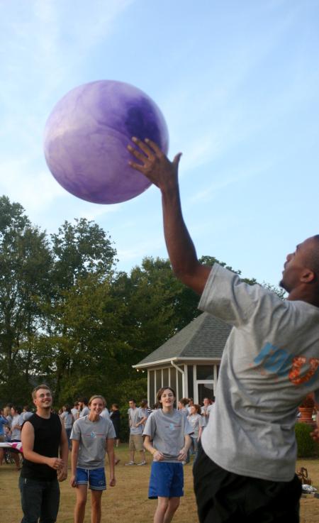 Once the big purple ball was brought out, students had a blast playing in a circle trying to keep it up in the air as long as possible without hitting the ground during the annual ice cream social at President Dockery's house. - Photo by Stephanie Schroeder