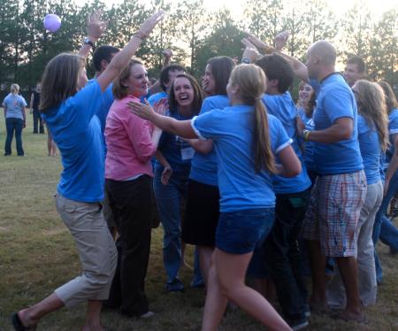 Dean of Students Kimberly Thornbury joins the Focus group leaders in a huddle after having completed some fun while imitating High School Musical at the annual ice cream social held at President Dockery's house. - Photo by Stephanie Schroeder