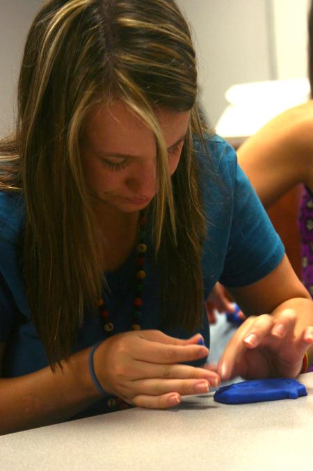 Mikaela Owens-Hughes works on a Play-Dough sculpture in her Focus group that will describe some aspect of her life. - Photo by Stephanie Schroeder