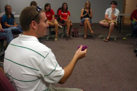 Spencer Plott, a sports medicine major from Paris, Tenn., displays his Play-Dough figure reflecting a bull that he owns to the rest of his Focus Group. Students were instructed to use the Play-Dough to create a material possession they value. - Photo by Stephanie Schroeder