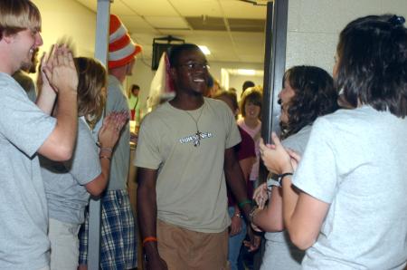 Toyin Adedokun, from Nigeria, flashes a smile as he is welcomed into the small gym for a Life Group presentation. - Photo by Stephanie Schroeder