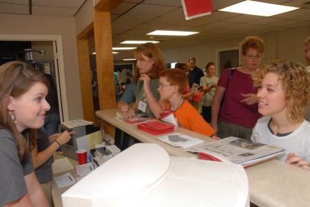 Hurt Residence Assistant Suzanne Short checks in freshmen as they arrive to move into their dorm room. - Photo by Kathleen Murray