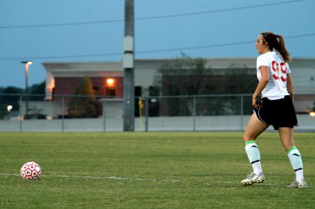 Sophomore Cara Pasley looks downfield as she prepares to kick the ball. - Photo by Matt Elia