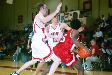Junior Mike Simpson (13) and Senior Matt Noah (22) double team a Hannibal La-Grange player. - Photo by Justin Veneman