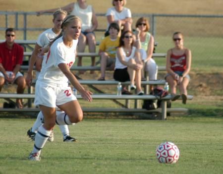 Amberly Armstrong dribbles the ball as Alicia Bennett watches the play. - Photo by Steven Aldridge