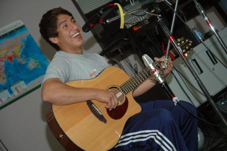 Freshman international business major Dennis Regalado of  St. Louis, Mo., sang a song at Open Mic about the first few days at college as a freshman.  - Photo by Neisha Fuson