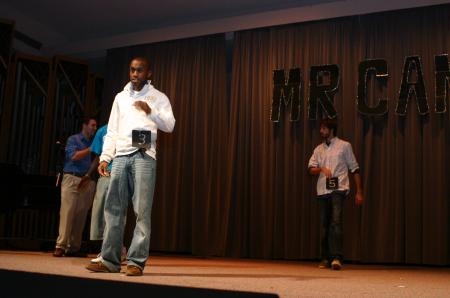 Sophomore Darrion Garrett poses on the walkway along with the other candidates of Mr. Campus, an event sponsored by PRSSA. - Photo by Stephanie Schroeder