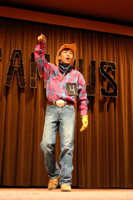 Freshman Chawalit Wongkhaio performs part of the electric slide and then follows it up with some stand-up comedy during the talent show portion of Mr. Campus, an event sponsored by PRSSA. - Photo by Stephanie Schroeder