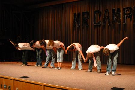 Sophomore Michael Grubb and his assitants give a bow at the end of Grubb's talent portion for Mr. Campus. - Photo by Stephanie Schroeder