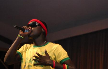 Freshman Eric Uwiringiyemana dances and raps during the talent portion of Mr. Campus. - Photo by Stephanie Schroeder