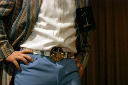 Junior Jonathan Lambach shows off his evening wear, including his spinner belt buckle, during Mr. Campus. - Photo by Stephanie Schroeder