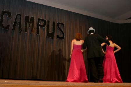 Carolyn Negley and Ashton Bruce escort Freshman Eric Uwiringiyemana out for his evening wear presentation during Mr. Campus. - Photo by Stephanie Schroeder