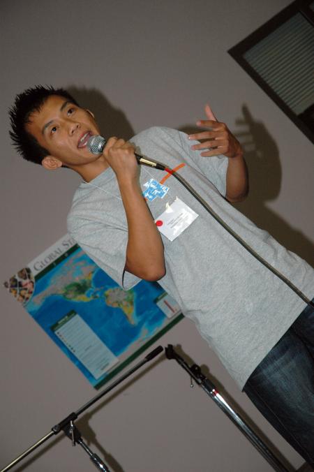 Chawalit Wongkhaio entertains at Open Mic night by telling funny stories about his new life in the United States.  - Photo by Neisha Fuson