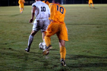 Senior Benny Crozier dribbles upfield with a Trevecca Nazarene defender in pursuit.  Union won the contest 2-1 on a rain-soaked field. - Photo by Matt Elia