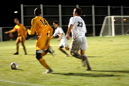 Freshman Franki Mocellin (23) and Paul Turner race two Trevecca Nazarene players into the corner in hopes of gaining ball possession. - Photo by Matt Elia