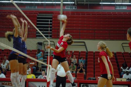 Junior Jennifer Martins spikes the volleyball back to her opponents from Trevecca Nazarene University.  - Photo by Neisha Fuson