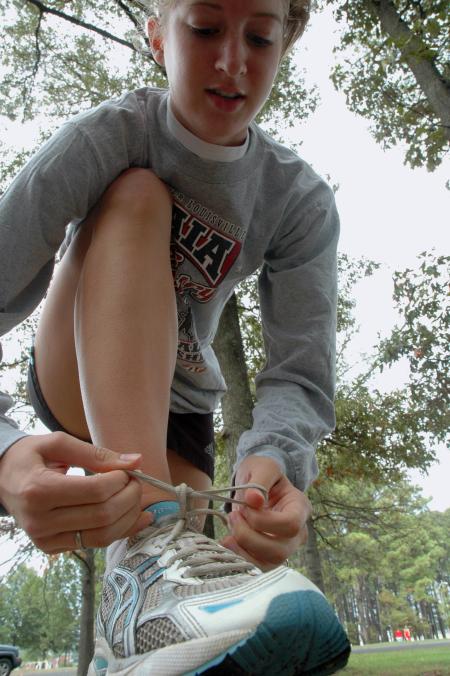 Junior Lydia Bond prepares to do a practice run around campus before a cross country meet.  - Photo by Neisha Fuson