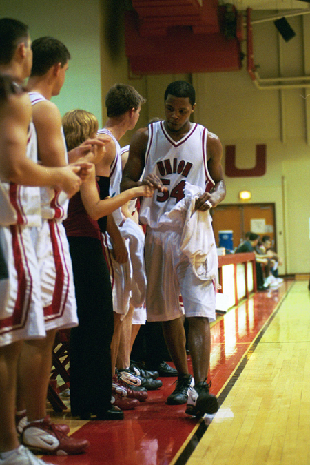 Senior Derrick Underwood (54) gets congrats from his teammates as he takes a rest. - Photo by Jim Veneman