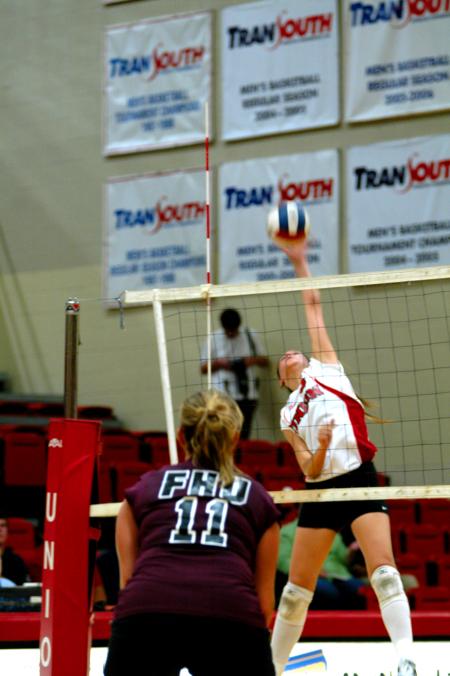 Junior Emilie Ogas attacks with a left-handed spike. - Photo by Matt Elia