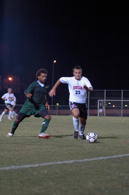 Freshman Franki Mocellin pushes himself to get past the opponent from Belhaven College.  - Photo by Neisha Fuson