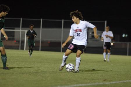 Freshman Edmundo Novarro uses some fancy footwork to keep the ball from the defenders from Belhaven College.  - Photo by Neisha Fuson
