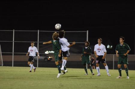 Union freshman Edmundo Novarro jumps with a Belhaven player as they battle for possession of the ball. - Photo by Neisha Fuson