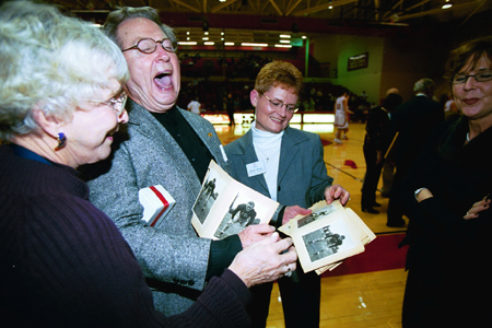 Union alum enjoy looking at old team photos from Union's football days during Homecoming 2003. - Photo by Jim Veneman