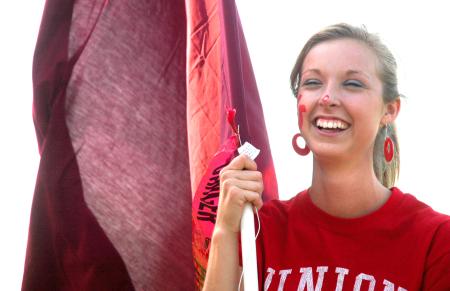 Freshman Juliana Robbins, public relations/advertising major, gets ready to charge into a Union soccer game waving a flag. - Photo by Matthew Diggs
