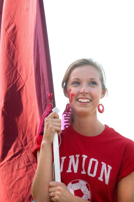Freshman Juliana Robbins, public relations/advertising major, gets ready to charge into a Union soccer game waving a flag. - Photo by Matthew Diggs