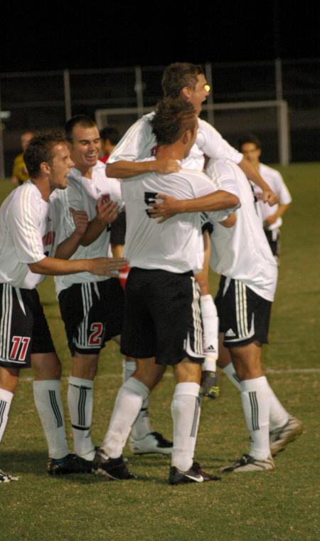The Bulldogs celebrate after scoring a goal in a game against Lyon College.   - Photo by Matthew Diggs
