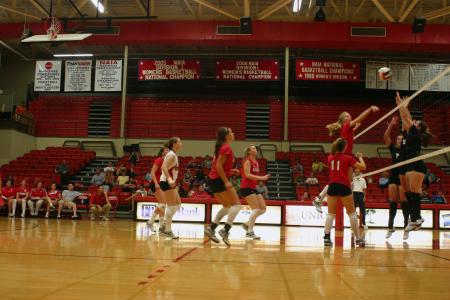 Junior Amanda Hutchison Coyle hits the ball over the net in a match versus Martin Methodist College (Tenn.). - Photo by Stephanie Schroeder