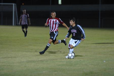 Sophomore Rafa Rodriguez watches where his teammates move to get the ball to them in the game against Martin Methodist College.  - Photo by Neisha Fuson