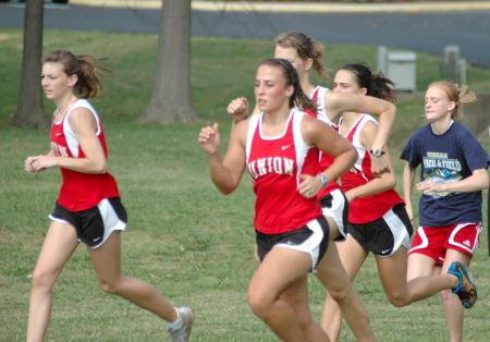 Candace Cross and Charlie Moss lead early in the Union Cross Country Invitational.  Union captured the race title. - Photo by Tommy Sadler
